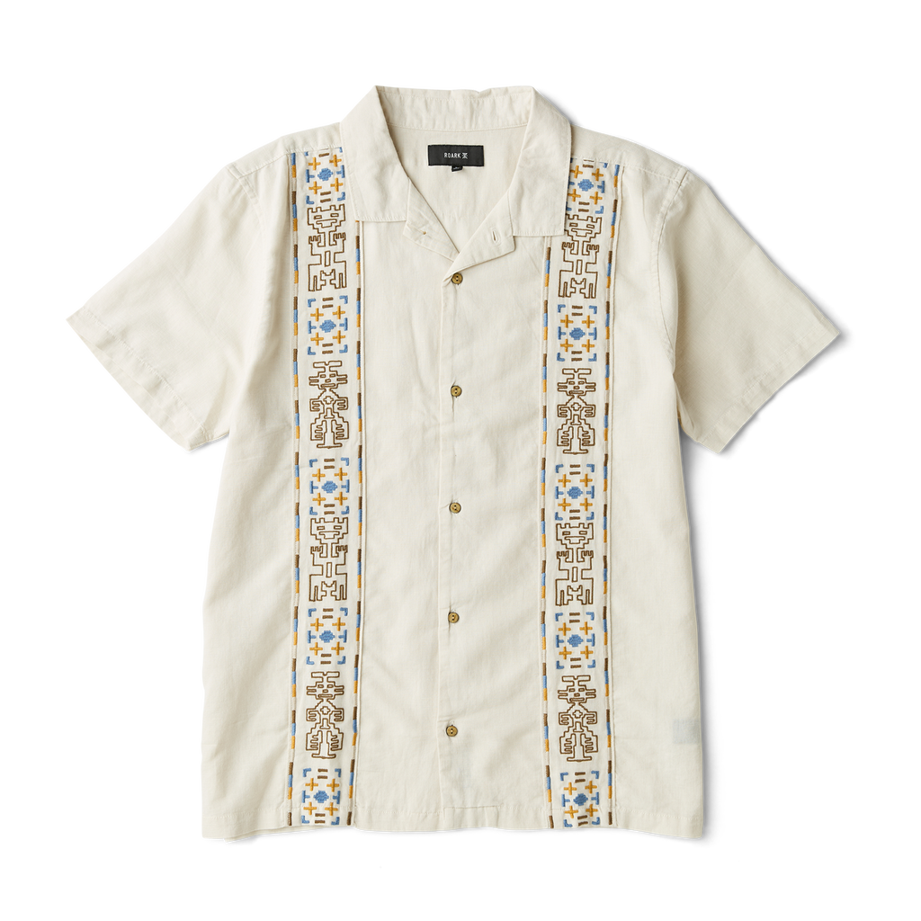 Close-up view of a rugged outdoor shirt featuring detailed stitching on the sleeve, sturdy collar, and secure buttons, perfect for adventure and travel. Big Image - 1