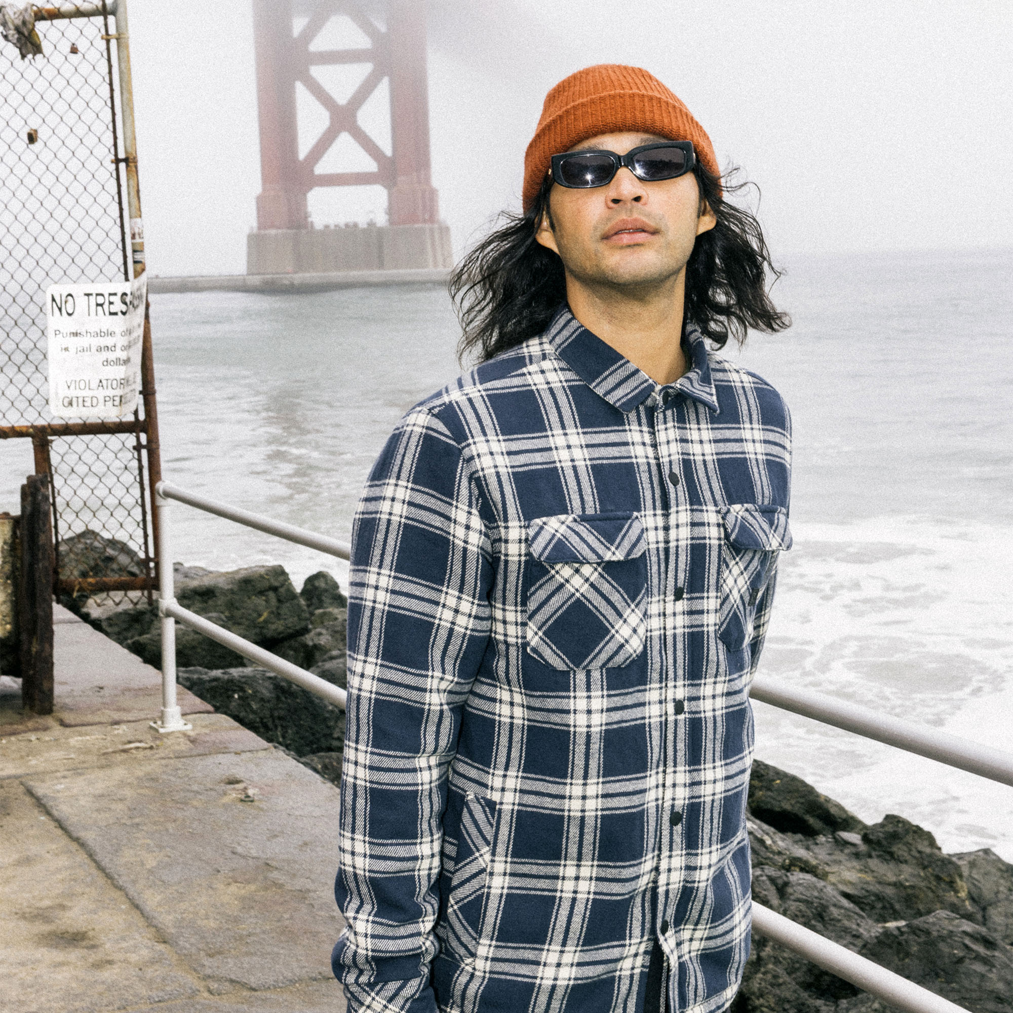 Stylish adventurer in the Backwoods Overshirt Jacket with eyewear, detailed collar, and rolled-up sleeves, ready for outdoor exploration.