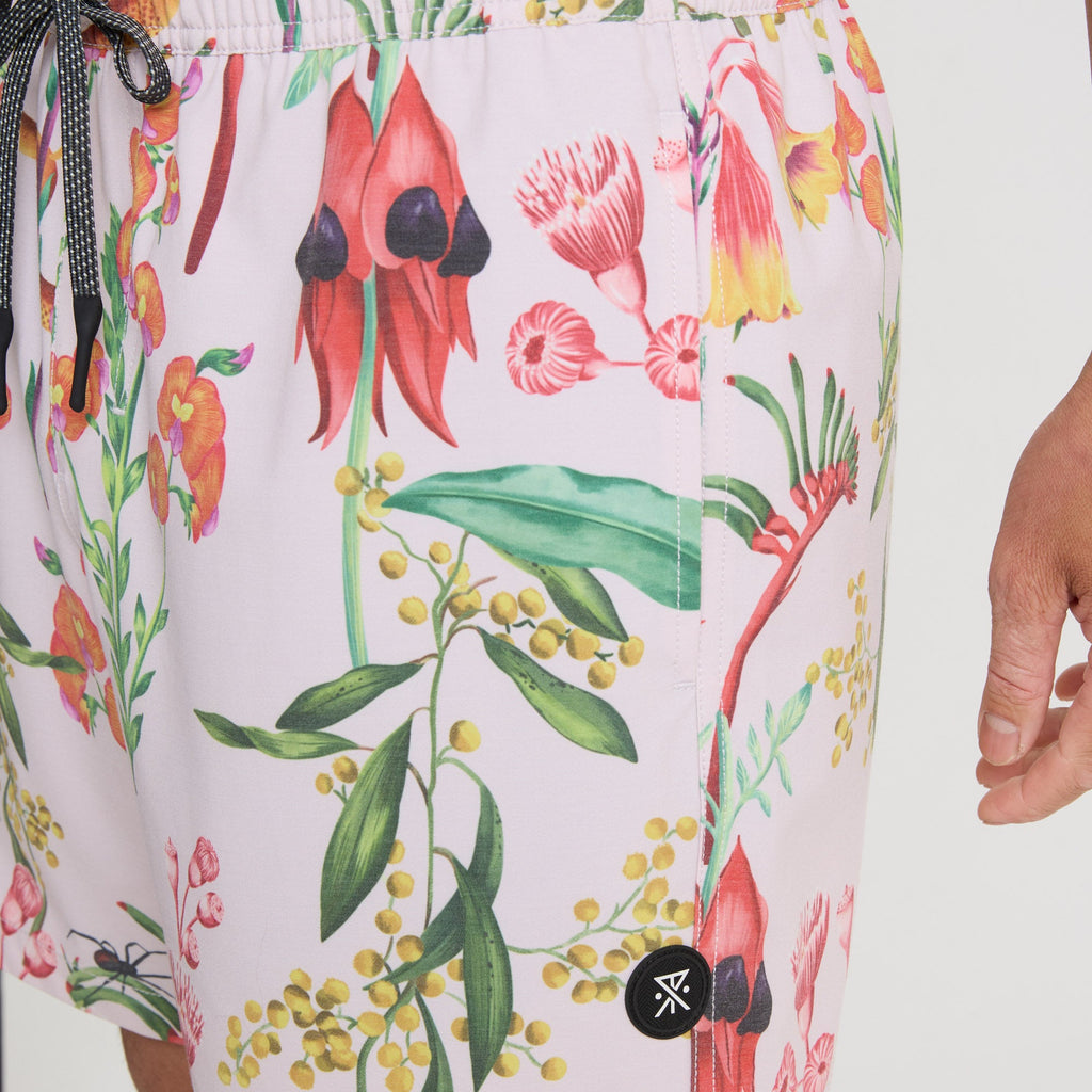 Man wearing pink Roark boardshorts while exploring vibrant outdoor settings, embodying a sense of adventure and travel. Big Image - 8