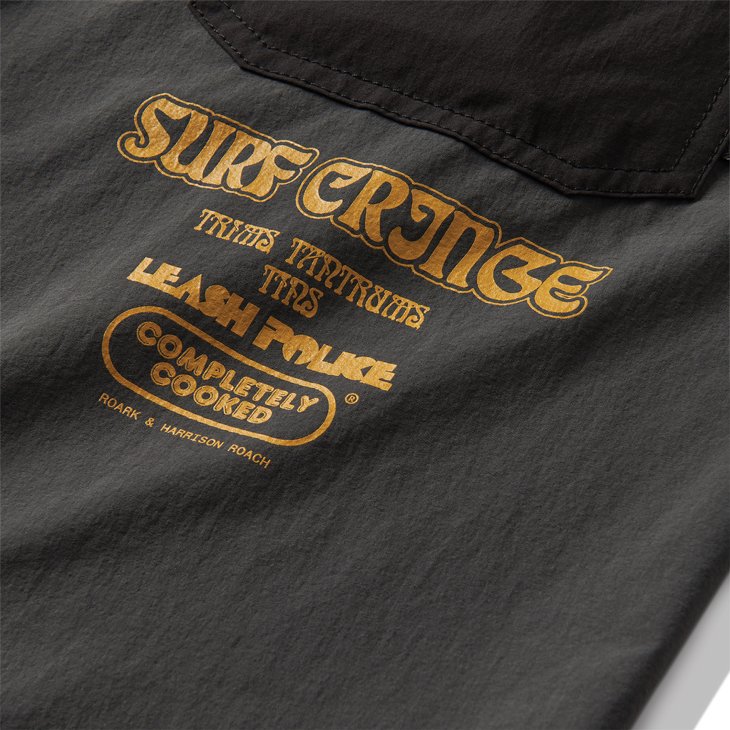 Close-up of a pocket on a Roark windbreaker in charcoal, designed for adventure travel and outdoor activities. Big Image - 11