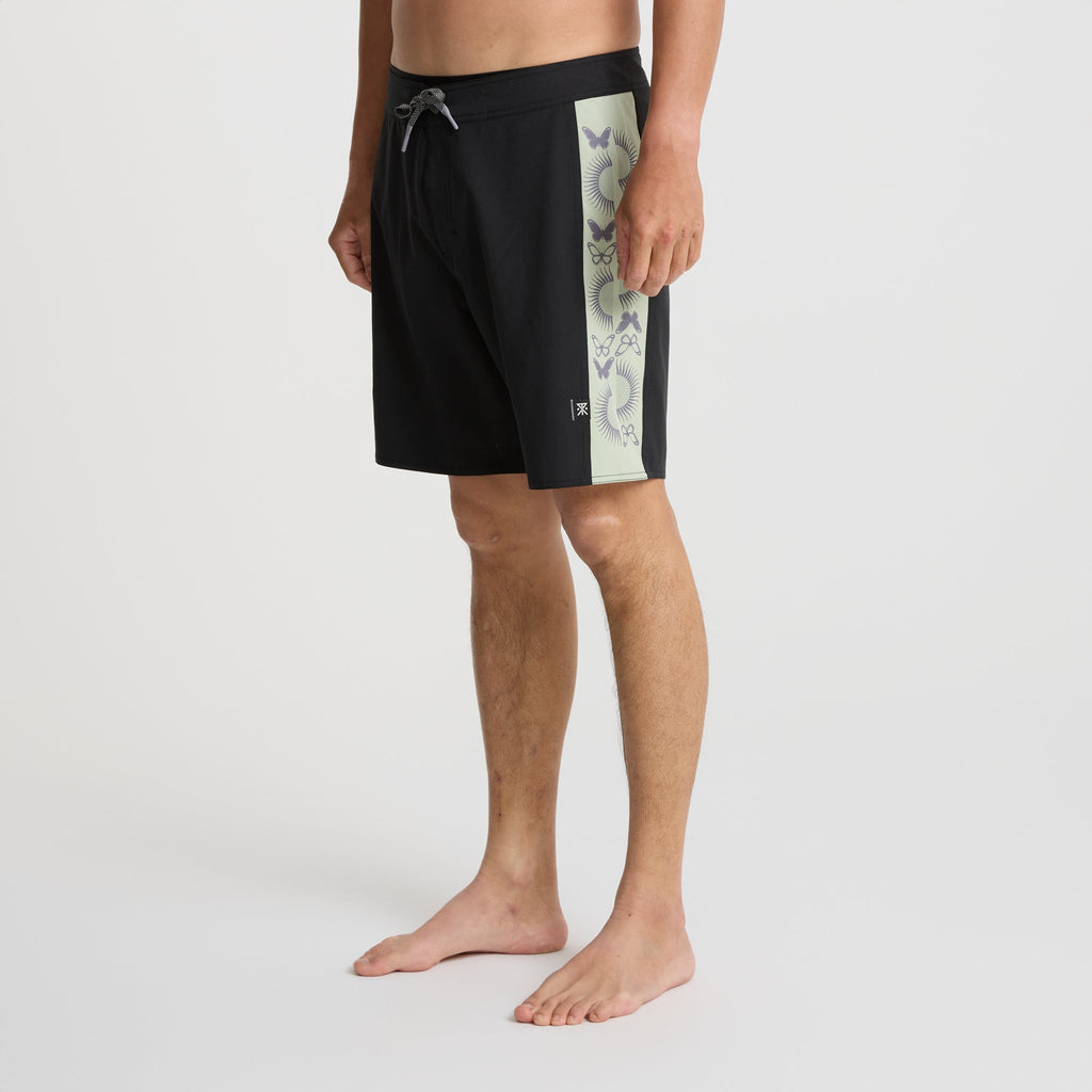 Versatile black Roark boardshorts displayed against a rugged outcrop, ideal for adventure and outdoor activities. Big Image - 3