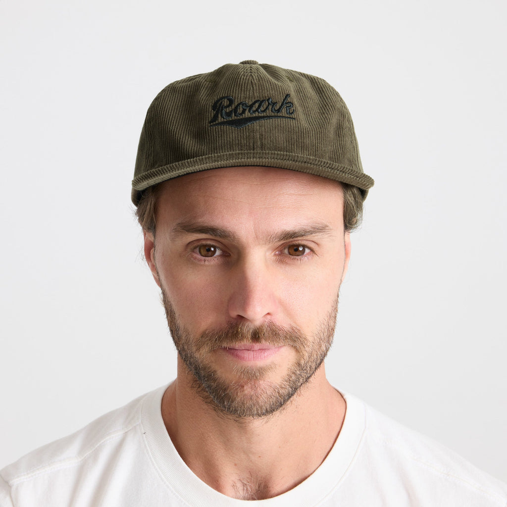 Adventurous man wearing a Roark baseball cap with rugged facial hair, embodying the outdoor and travel spirit. Big Image - 3