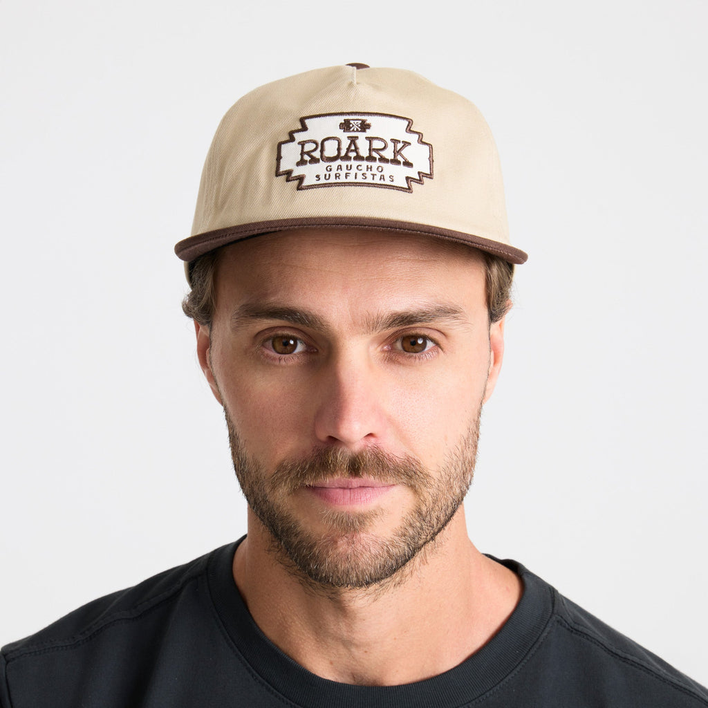 Man with a rugged beard wearing a versatile Roark cap on an adventure. Big Image - 7
