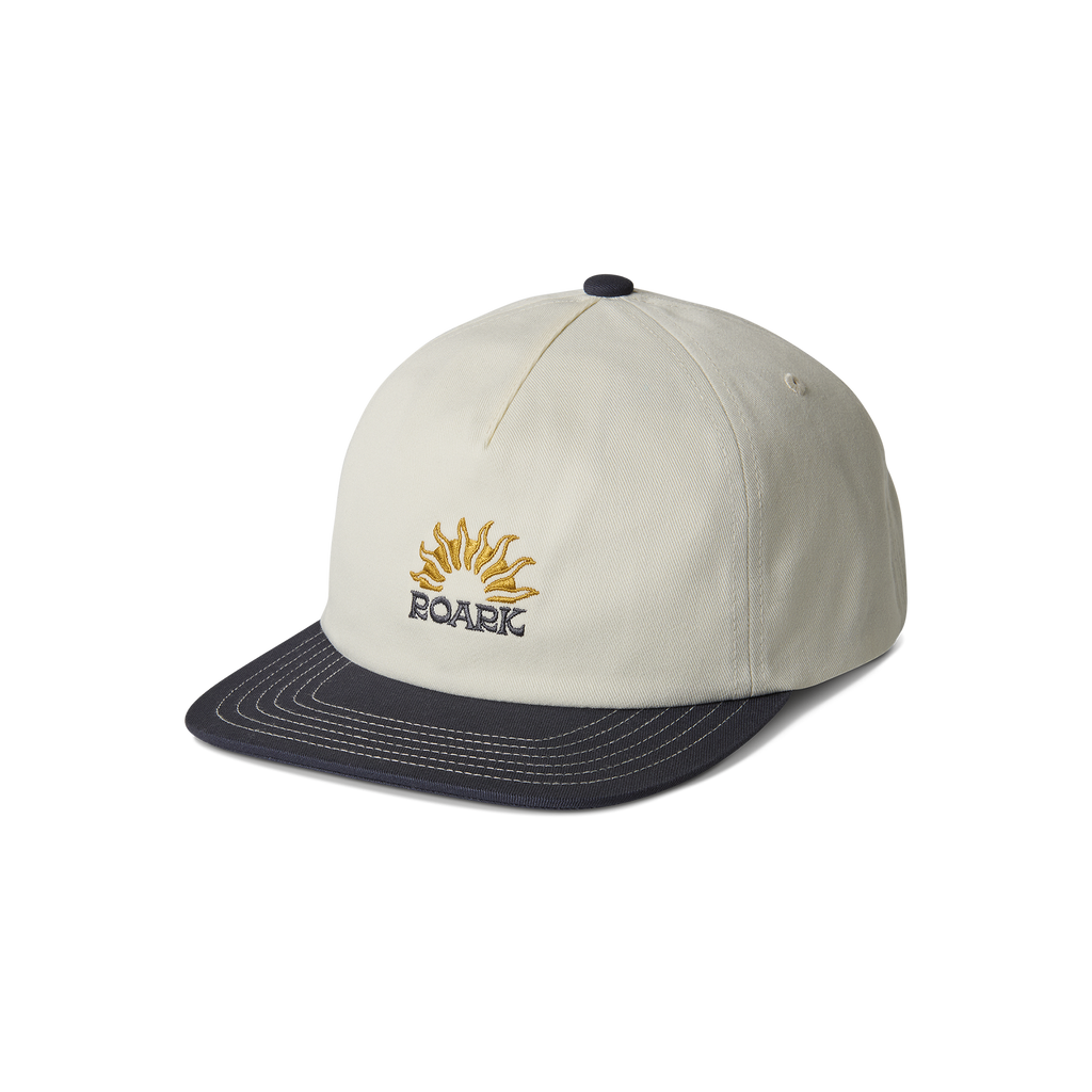 Cricket cap set against a tranquil outdoor background, embodying Roark's spirit of adventure and travel. Big Image - 7