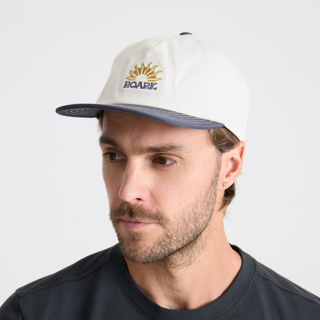 Stylish Roark cricket cap against a scenic outdoor backdrop, perfect for adventure and travel. Big Image - 3