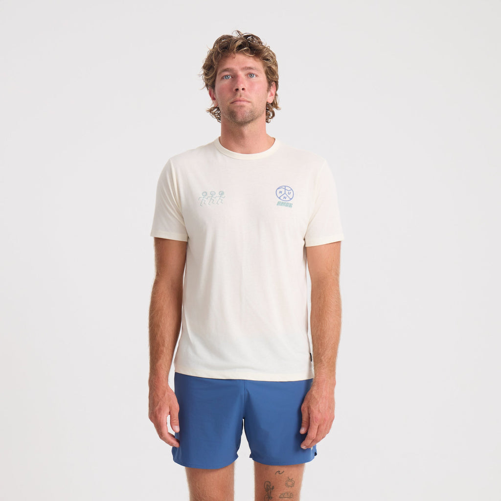 Man wearing blue active shirt and boardshorts engaged in outdoor adventure activities, showcasing Roark's style and durability in active wear. Big Image - 2