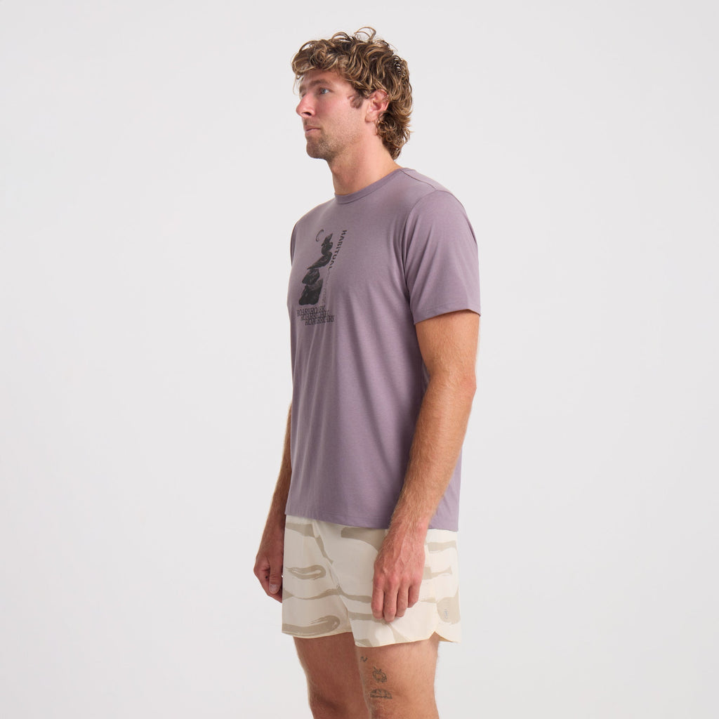 Model wearing Roark active outdoor apparel, featuring an active shirt paired with boardshorts, ideal for adventure and travel. Big Image - 3