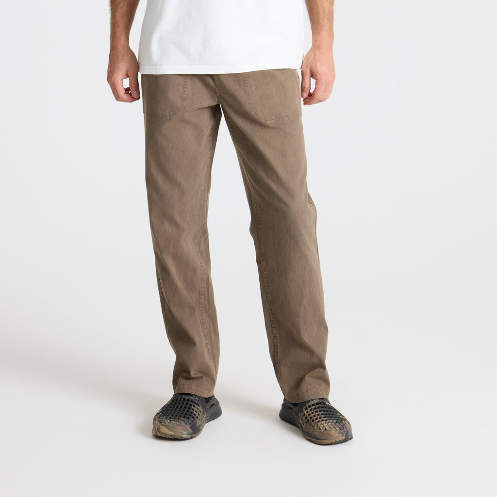 Versatile khaki cargo pants with multiple pockets, ideal for outdoor adventures and travel, displayed in a natural setting Big Image - 3