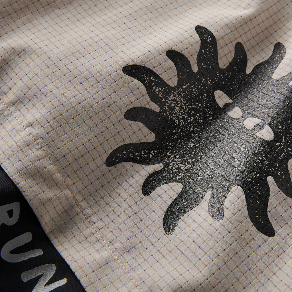 Detailed view of black sun graphic on Roark running shorts, showcasing stylish design and high-quality print for a bold statement. Big Image - 13