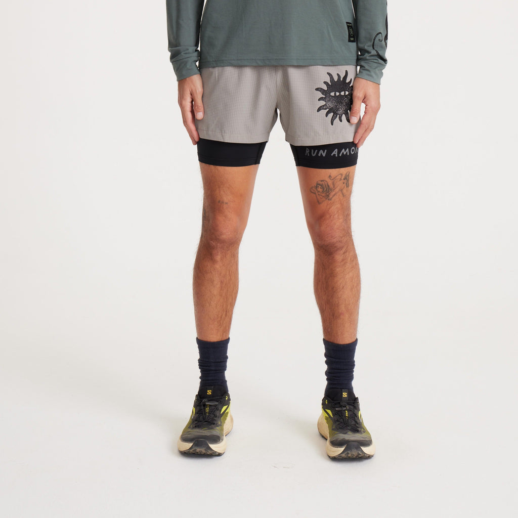 Full front view of Roark running shorts with black liner and sun graphic, designed for high-performance outdoor activities. Big Image - 2