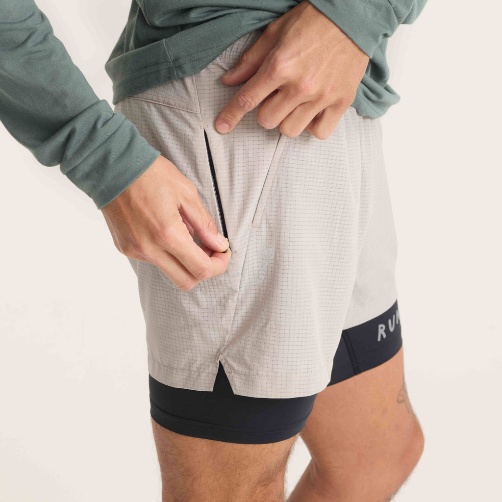 Close-up of zippered pocket on Roark running shorts, showcasing secure storage for essentials during outdoor activities. Big Image - 5