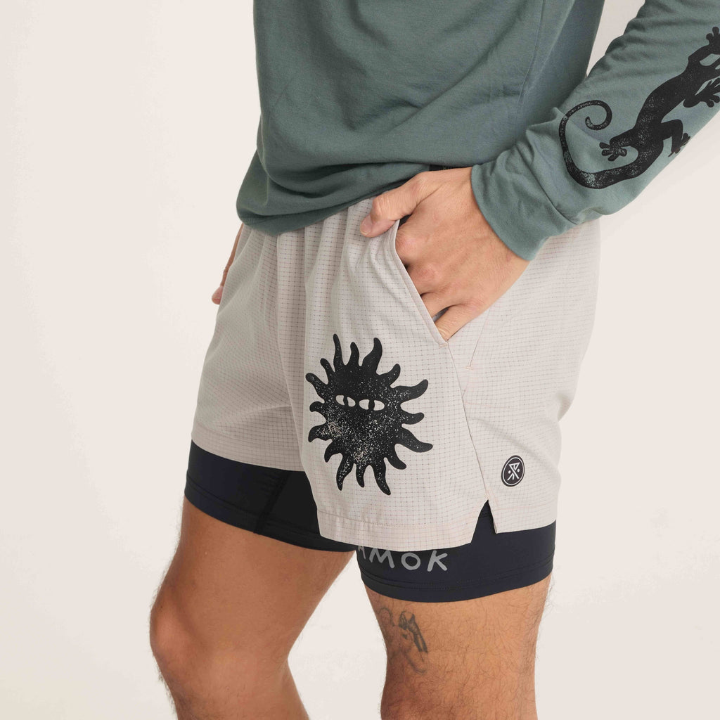 Side view of grey Roark running shorts featuring a bold sun graphic and streamlined design for comfort and style. Big Image - 6