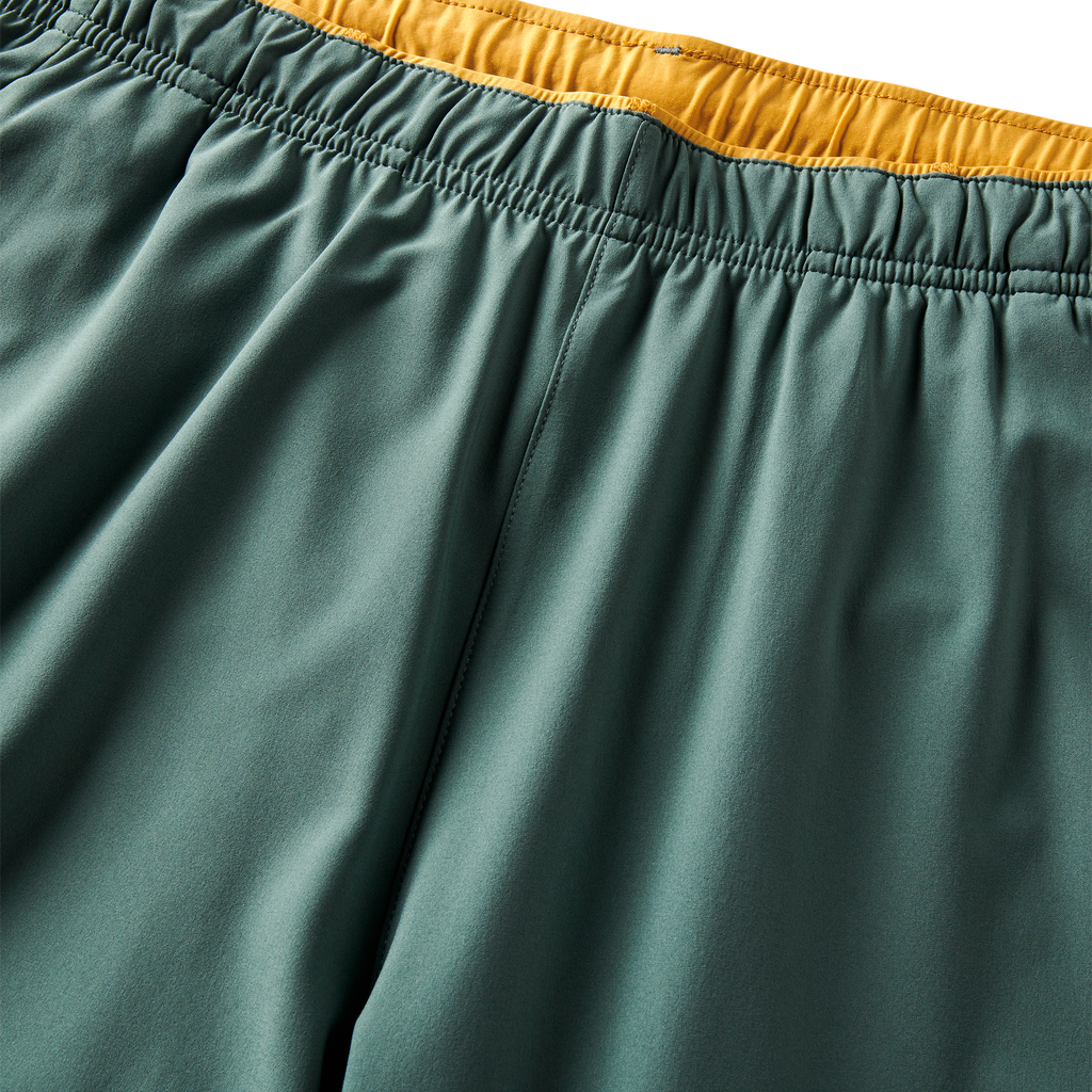 Close-up of the elastic waistband on Roark performance shorts, showcasing the yellow interior detailing. Big Image - 10