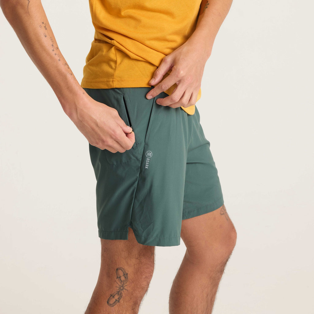 Zoomed-in view of green running shorts with 'Open Roads Open Minds' graphic and lightweight fabric, styled with a yellow T-shirt. Big Image - 7