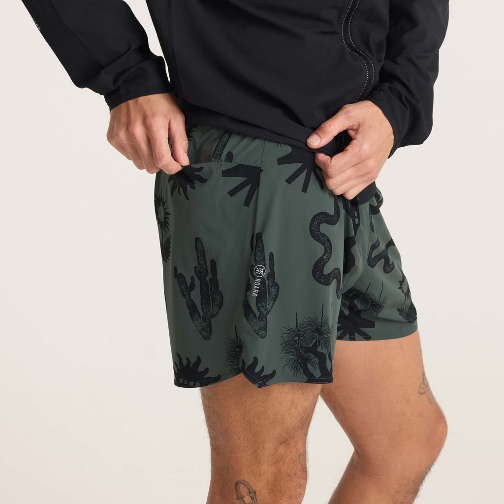 Close-up of running shorts pocket detail with graphic prints, emphasizing functional and stylish sportswear design. Big Image - 5