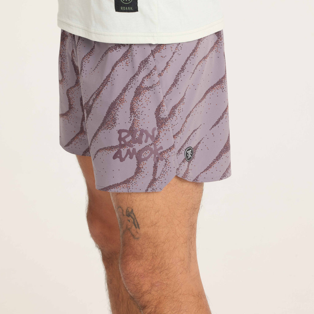 Close-up of purple wave running shorts, featuring the 'Run Amok' graphic and side logo for a statement athletic look. Big Image - 10