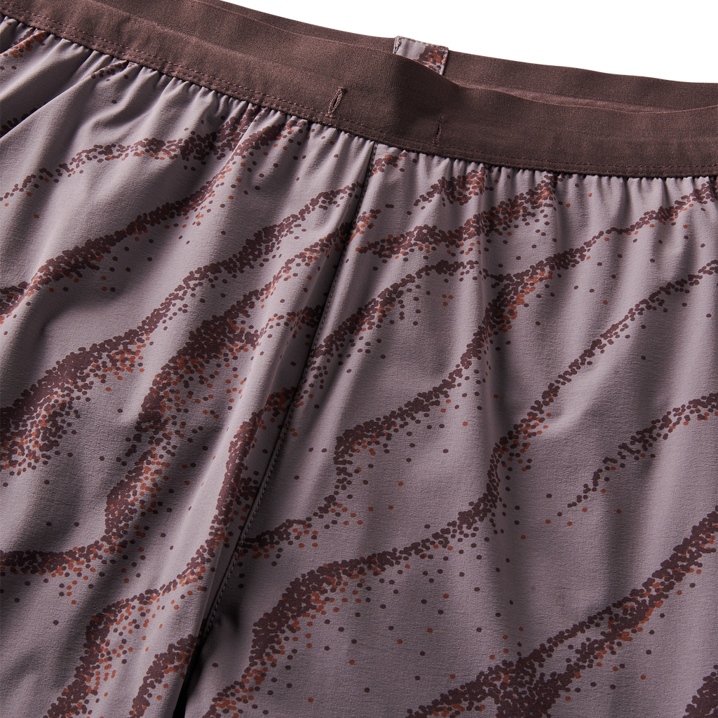 Close-up of purple patterned waistband detailing on performance running shorts for a stylish and functional look. Big Image - 12