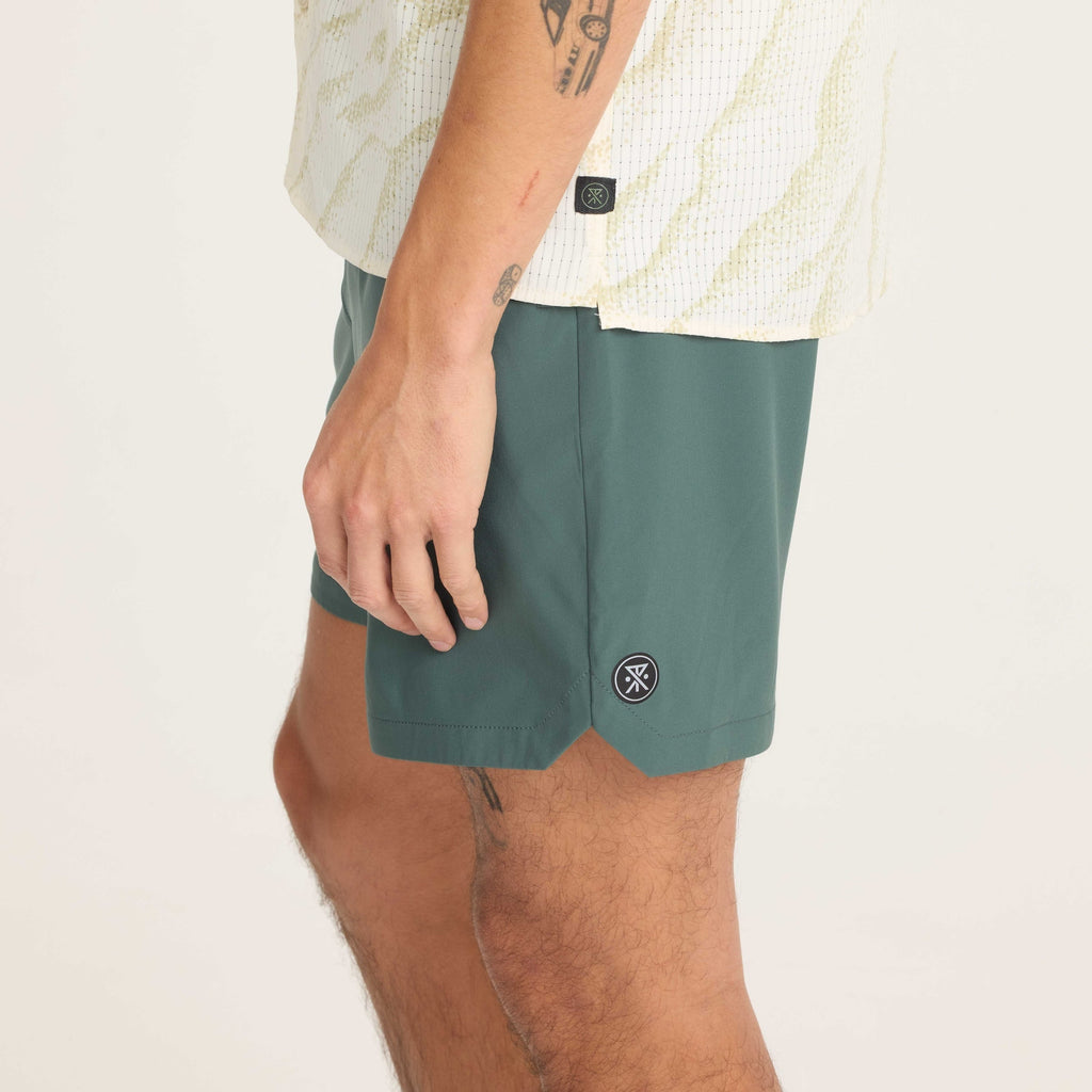 Side profile of green men's shorts showcasing durable material and a comfortable fit for versatile use. Big Image - 9