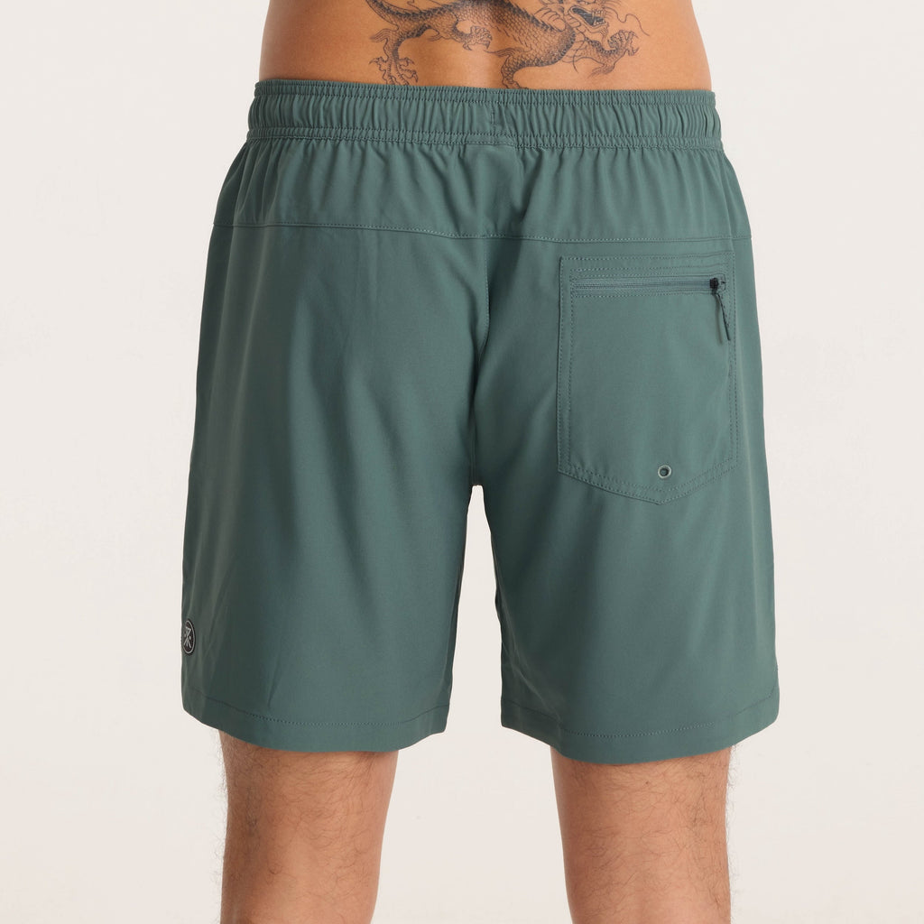 Back view of green men's active shorts with zippered pocket and elastic waistband for outdoor adventures. Big Image - 7