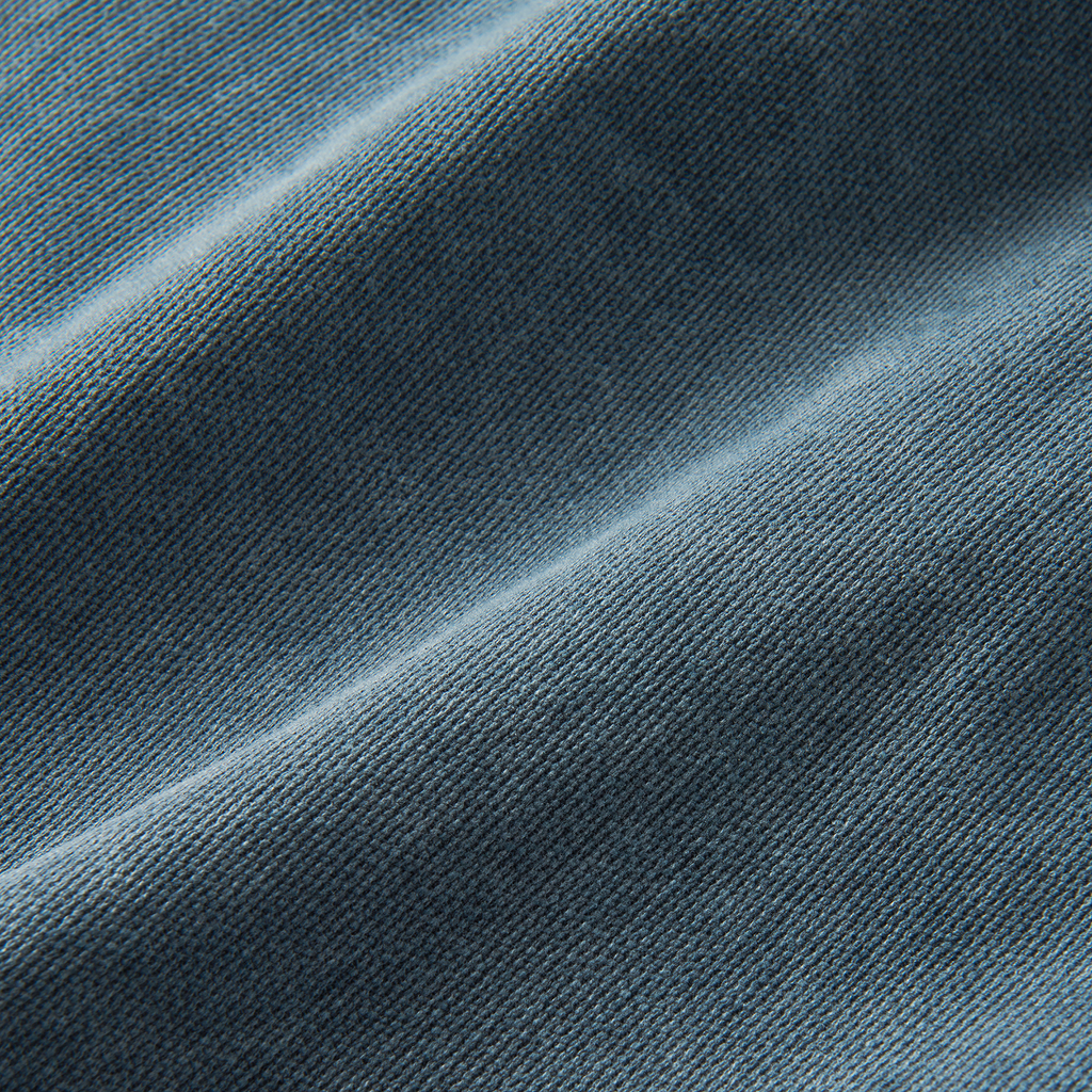 Close-up of textured woven fabric in shades of blue representing durable outdoor apparel, ideal for adventure and travel. Big Image - 9