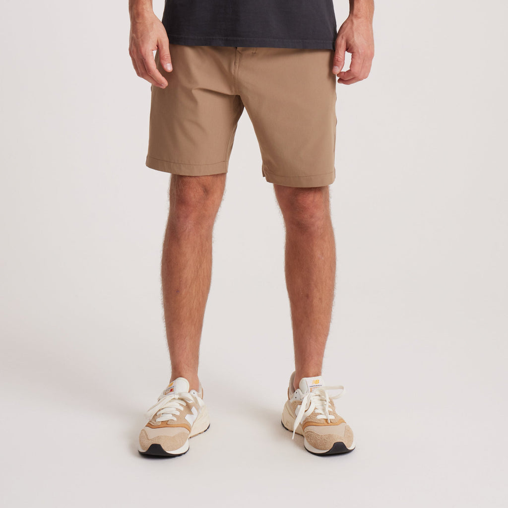 on-model Front view of men's tan hybrid shorts, showcasing a sleek design with functional front pockets and durable construction for everyday wear. Big Image - 6
