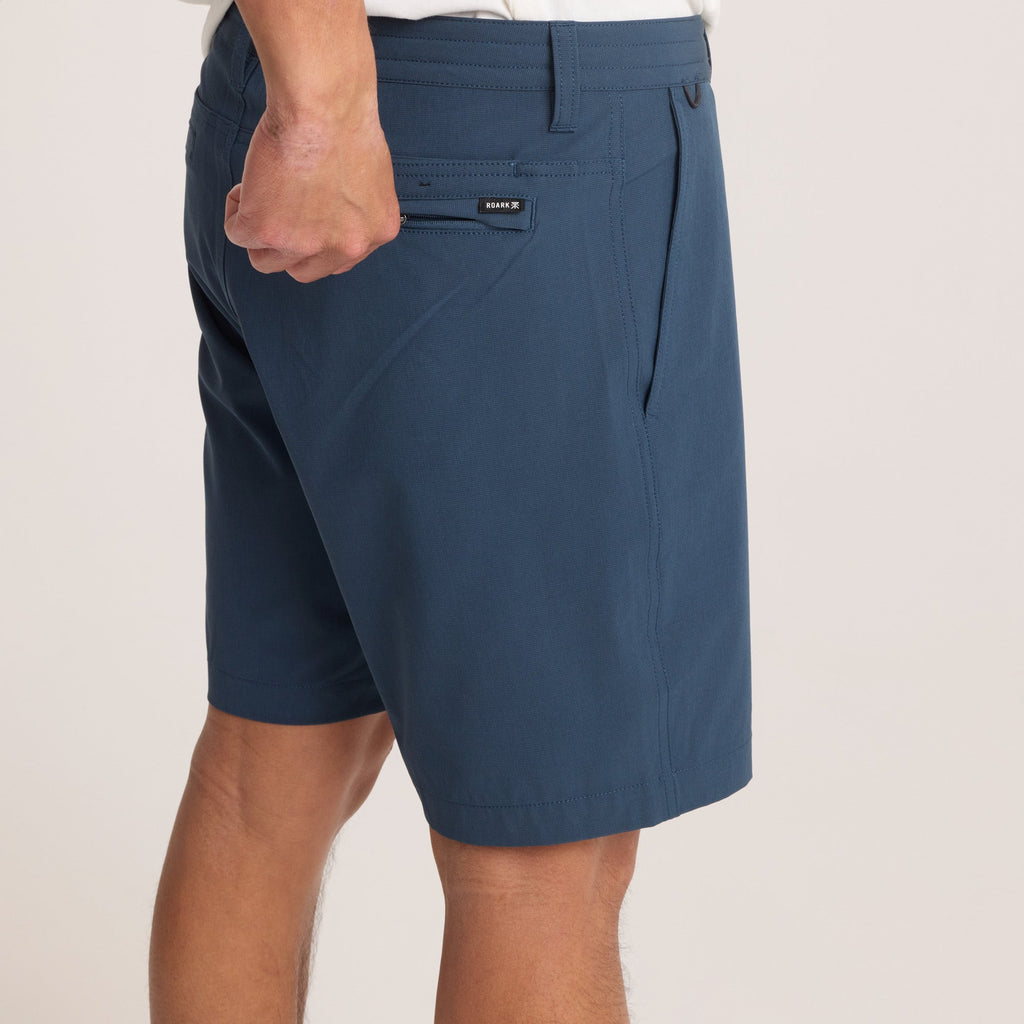 Back close-up of navy hybrid shorts highlighting the branded zip pocket, ensuring secure storage and added style. Big Image - 8