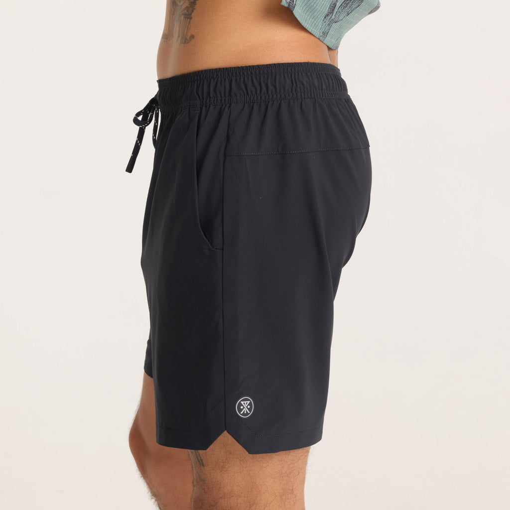 Close-up side view of black Serrano athletic shorts worn by model, featuring the Roark logo and water-resistant fabric finish. Big Image - 8