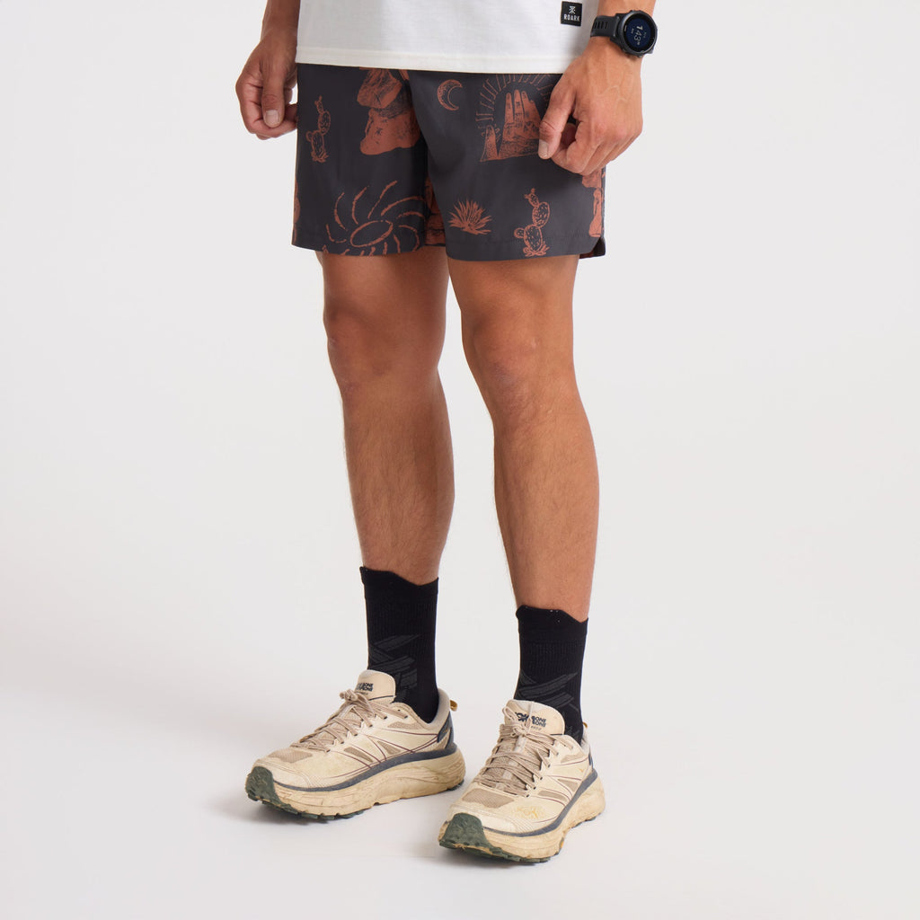 Active man wearing Roark brown and orange boardshorts, perfect for outdoor adventure and travel. Big Image - 3