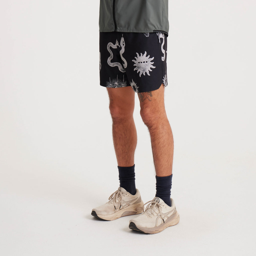 Side view of black swim shorts with unique white graphic prints, highlighting the shorts' modern fit and versatile style for summer activities. Big Image - 4