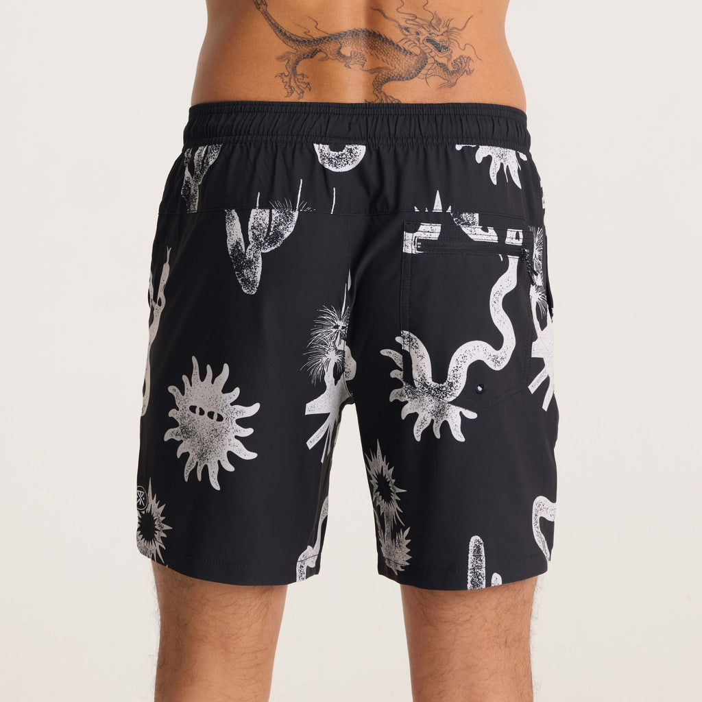 Model displaying the back of black swim shorts with intricate white desert-themed prints, styled for a casual and adventurous summer look. Big Image - 7