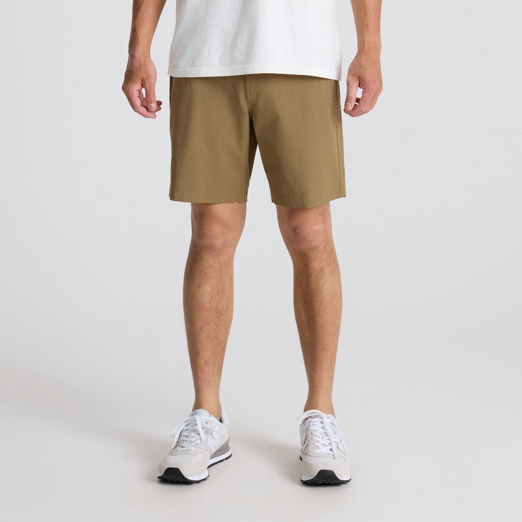 Active man in dark Bermuda shorts on a travel adventure, showcasing Roark's practical and stylish outdoor attire. Big Image - 3