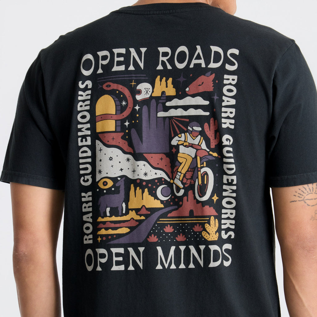 Stylish black active shirt featuring a unique graphic design, paired with durable denim on a track setting, perfect for adventure and travel. Big Image - 6