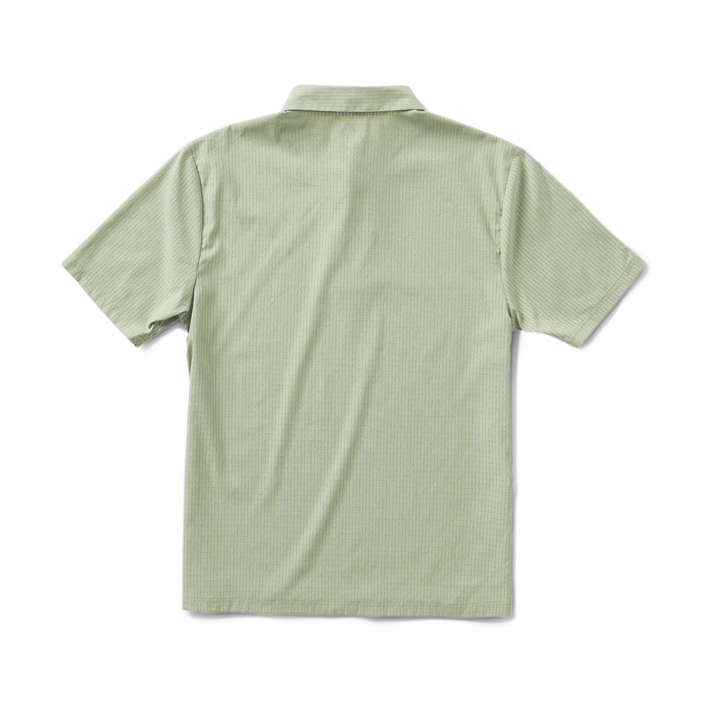 Close-up of the chest pocket and Roark logo on the dusty green Bless Up Breathable Stretch Polo Shirt. Big Image - 2