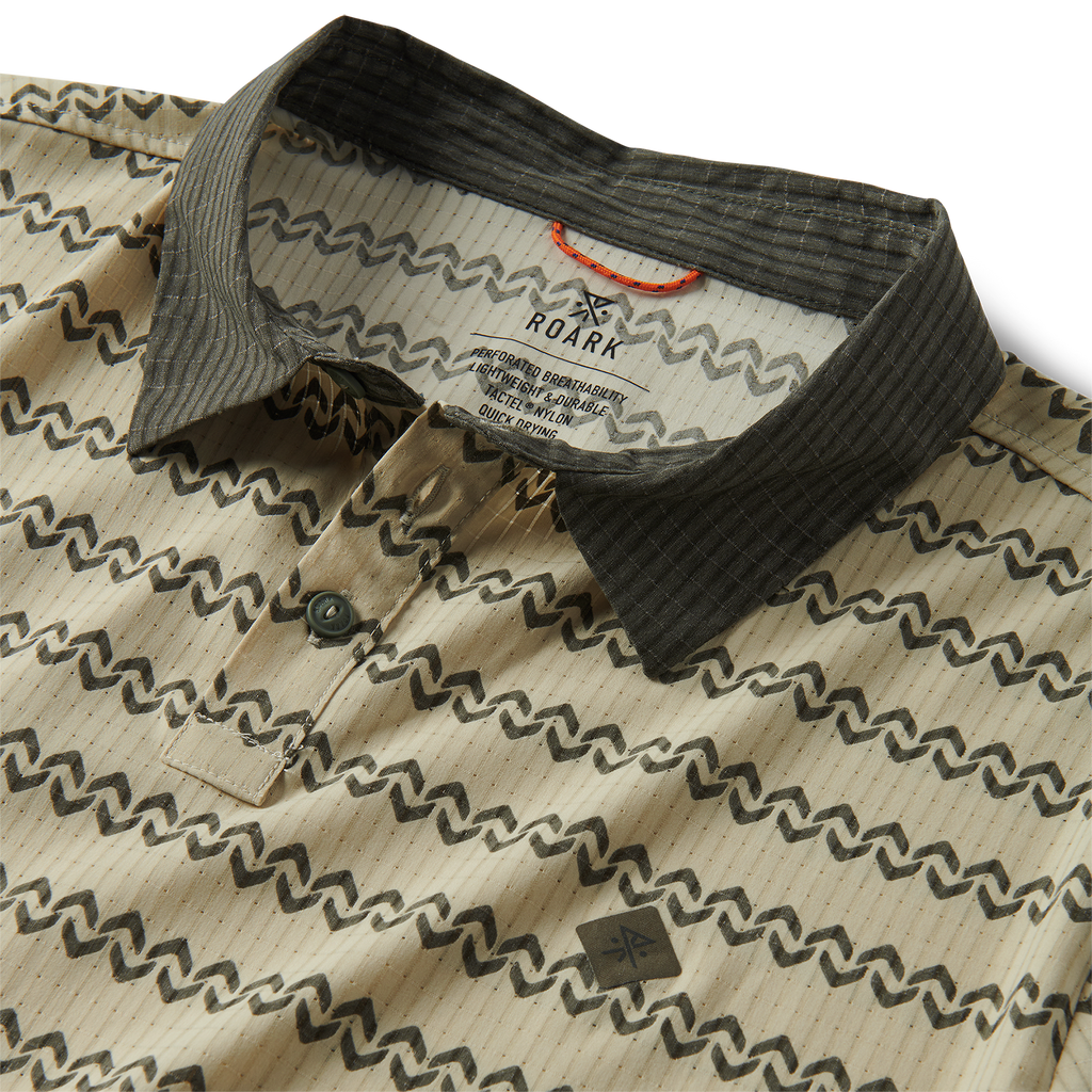 Detail of a stylish dress shirt featuring a collar, intricate pattern, and buttons, embodying Roark's spirit of adventure and travel. Big Image - 11