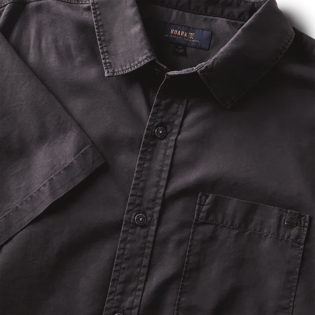 Close-up of black button-up shirt details, highlighting the buttons, collar, and front pocket for a refined look. Big Image - 7
