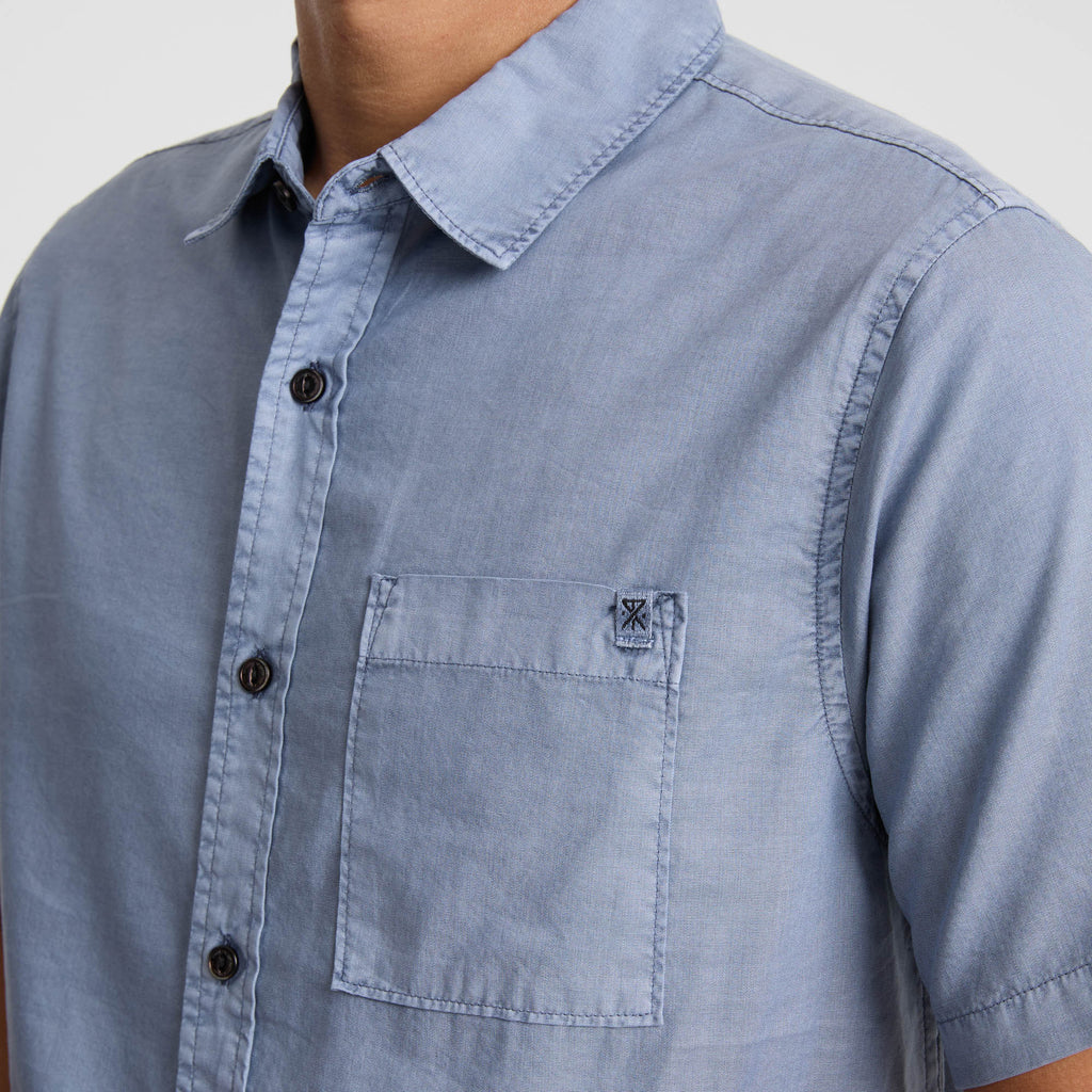 Detail of a linen Roark shirt featuring a collar, button, and pocket, ideal for outdoor and travel adventures. Big Image - 8
