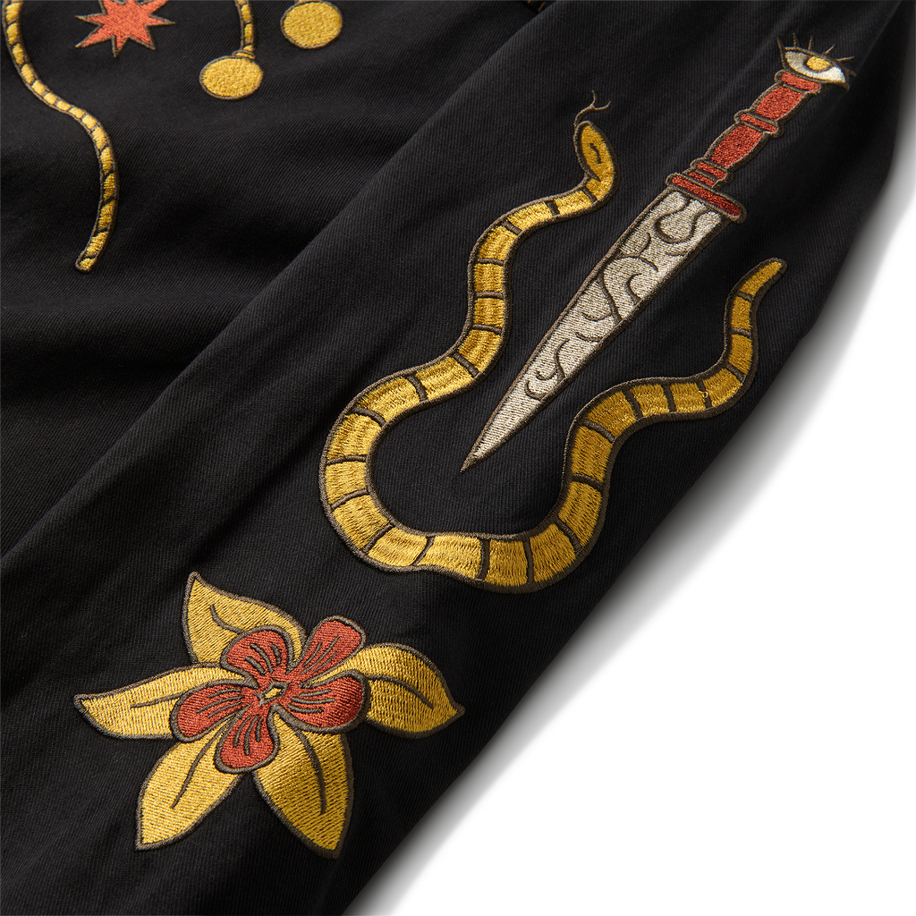 Close-up of intricate black embroidery with unique patterns on a Roark adventure apparel. Big Image - 12