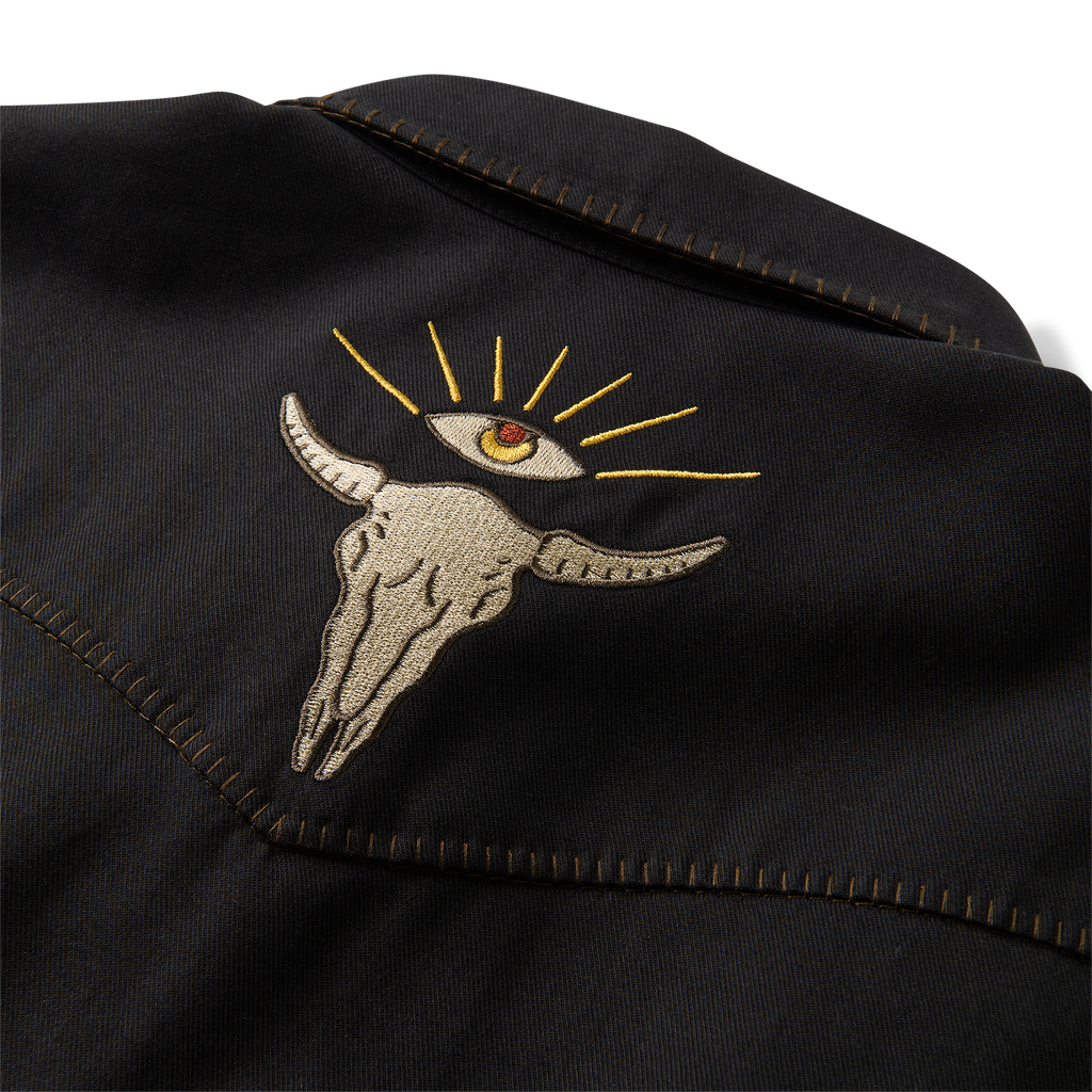 Close-up view of a black leather jacket detailing with focus on pocket and button, exuding a rugged, adventure-ready style by Roark. Big Image - 13